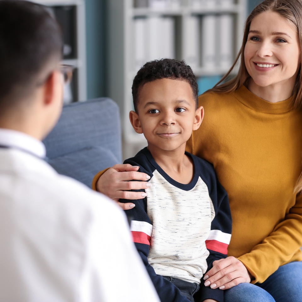 African-American boy with mother at pediatrician's office