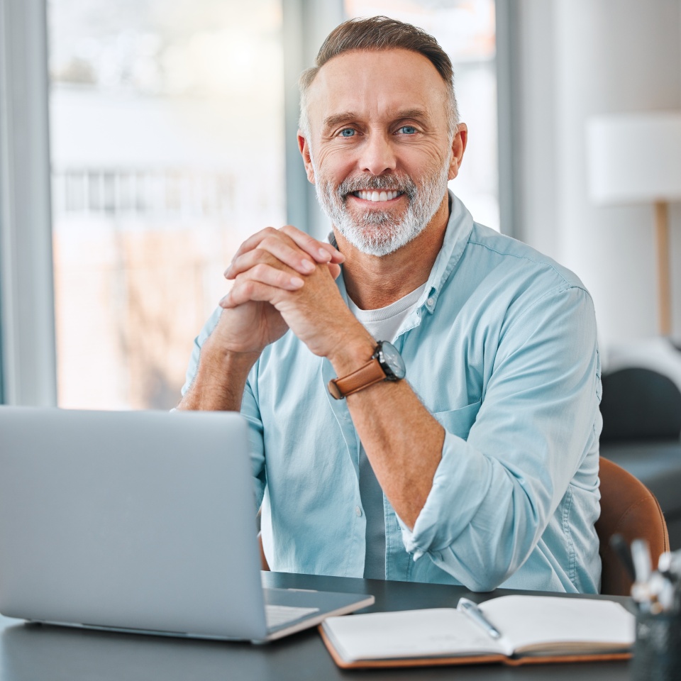 Ive worked hard to be here today. Shot of a mature businessman sitting alone in his home office and using a laptop.