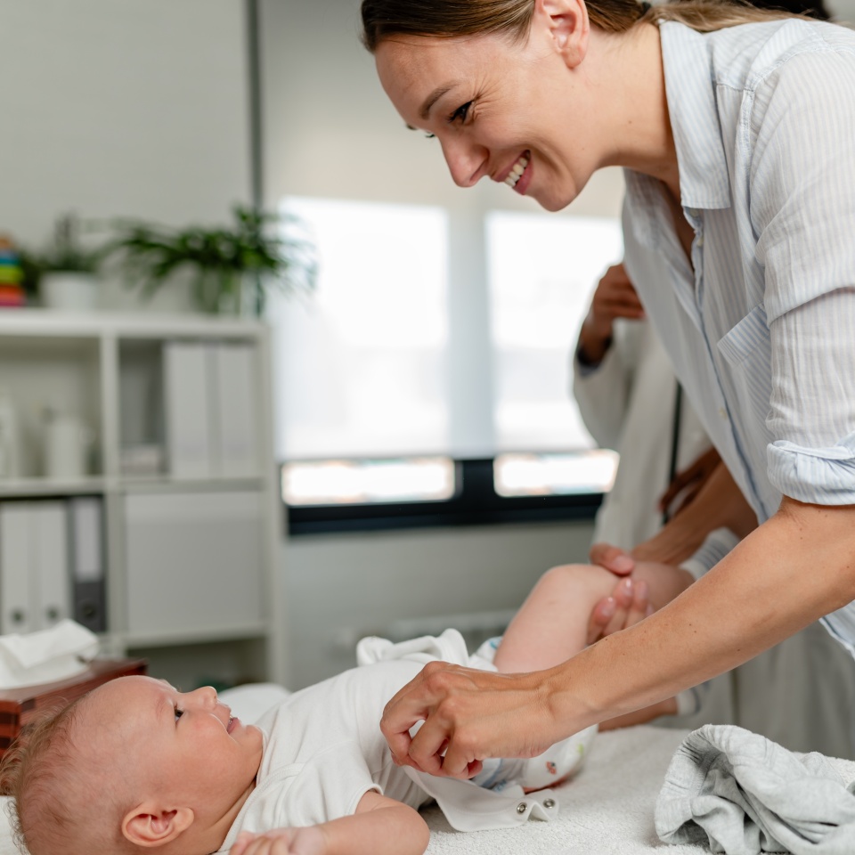 Appointment with a consultant pediatrician. Mother and baby at pediatrician's office.