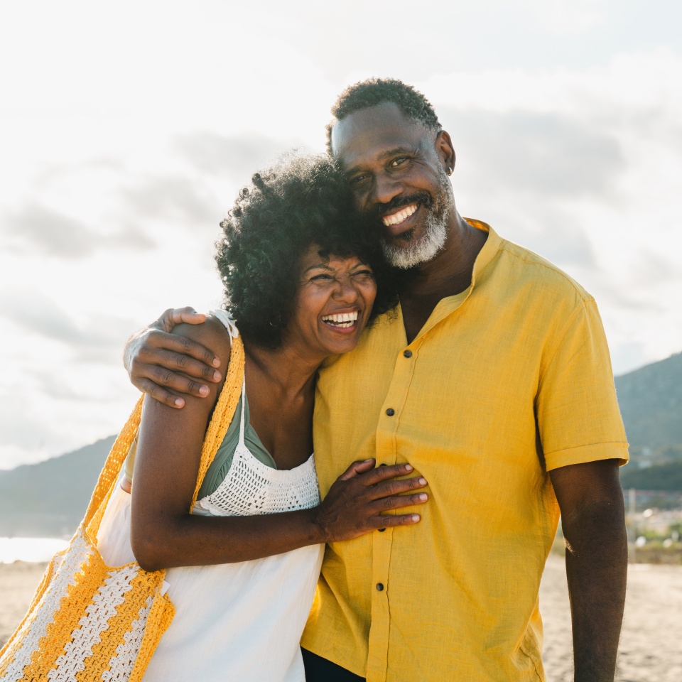 Beautiful mature black couple of lovers dating at the seaside - Married african middle-aged couple bonding and having fun outdoors, concepts about relationship, lifestyle and quality of life