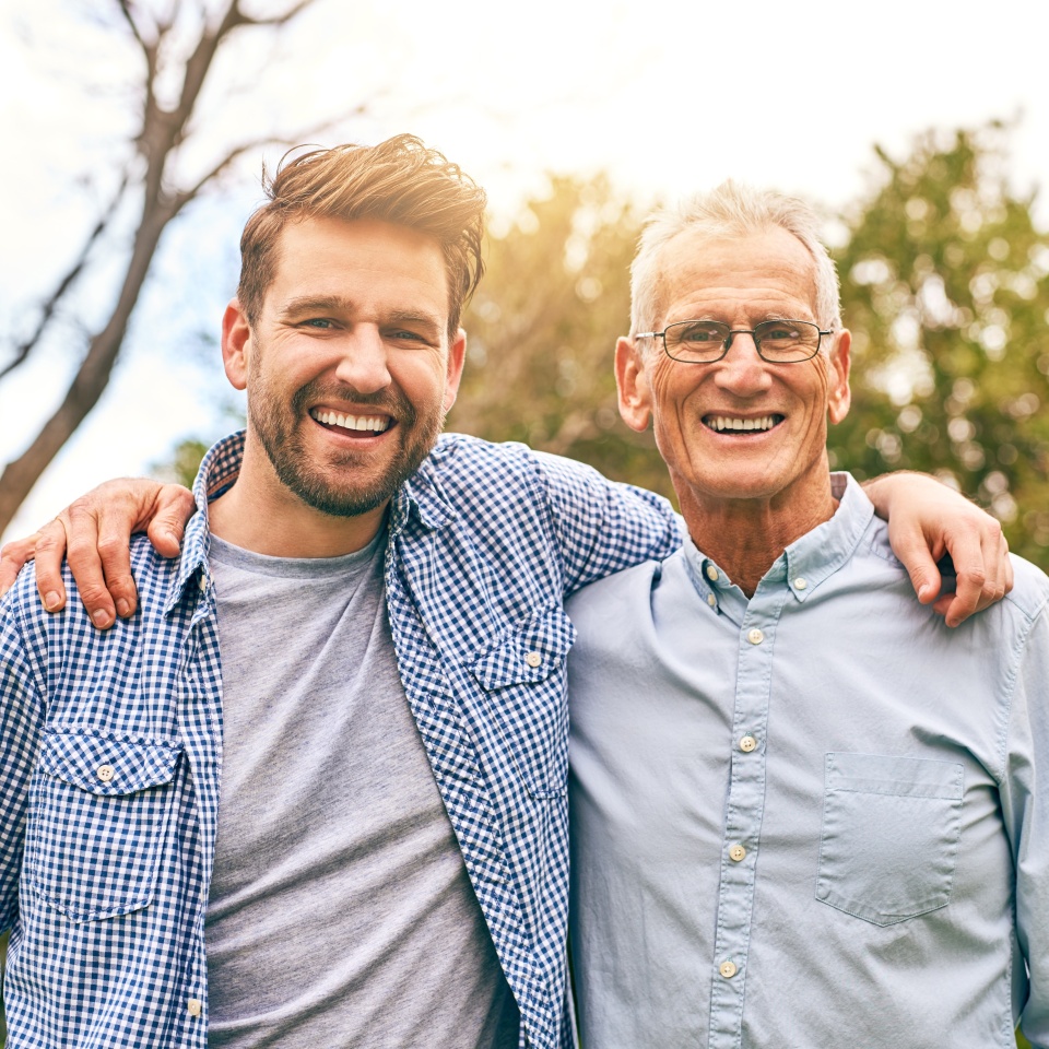 Man, father and outdoor portrait with hug, vacation and support in relationship connection. Son, senior dad and together for security embrace in countryside, love and retirement travel for bonding