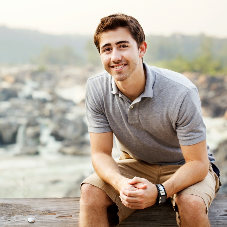 Young man sitting at a waterfall park in Great Falls Virginia