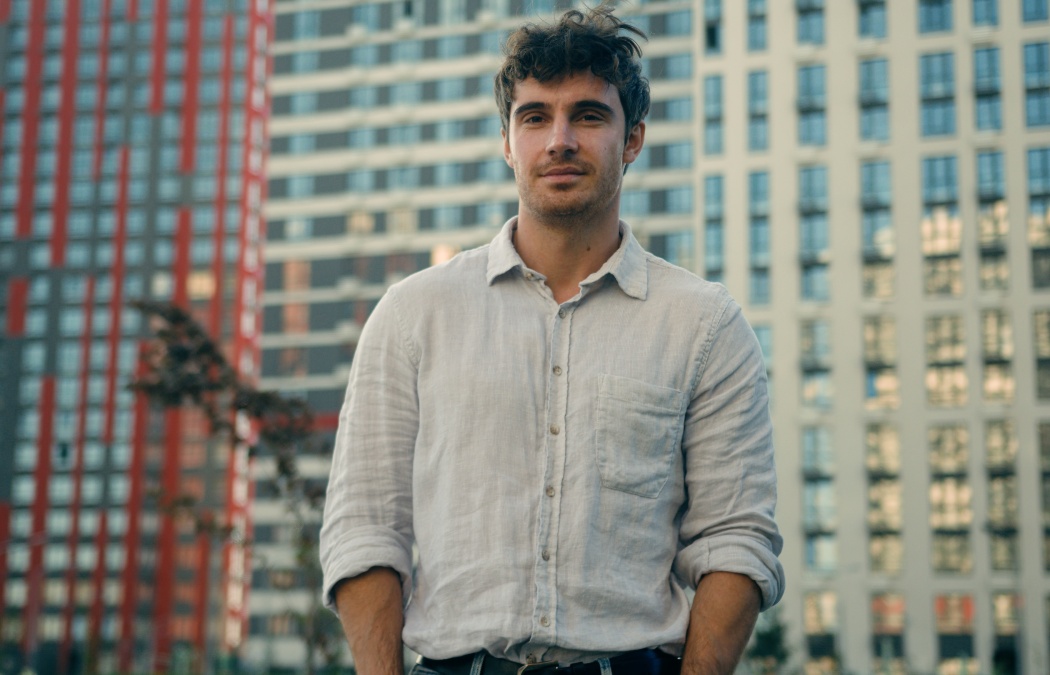 Caucasian man millennial thoughtful male looking away outdoors confident calm guy businessman look camera smile confidence handsome model boyfriend tourist on modern urban buildings background in city